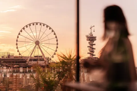 Girl next to the ferris wheel at Scheveningen