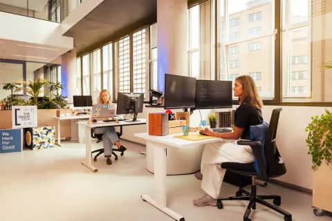 Woman working behind computer in a startup hub
