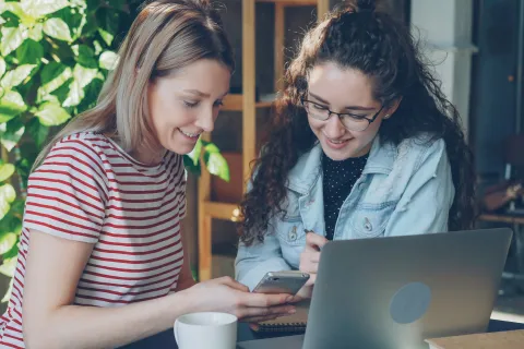 Two women looking at phone