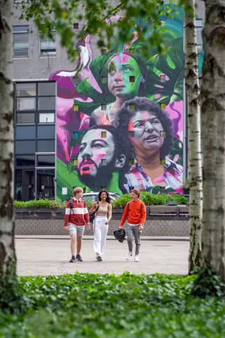 Students in front of graffiti
