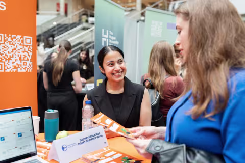 Woman talking to each other at a career fair — Holland Park Media