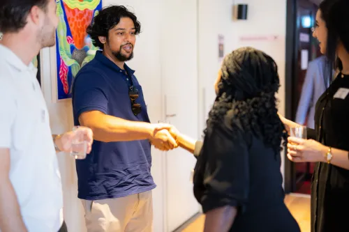 Two people shaking hands at an event