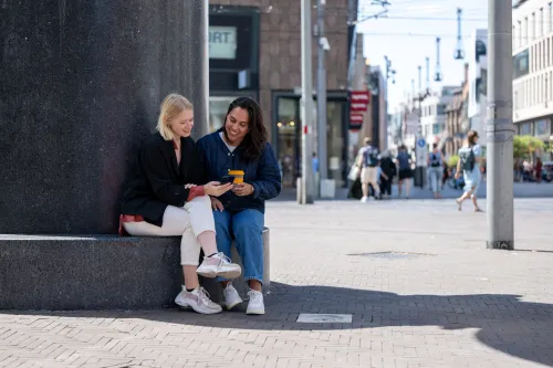 Woman looking at their phone in The Hague