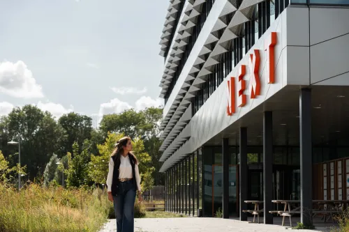 Woman walking outside office building