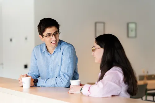 Male and female colleague office coffee